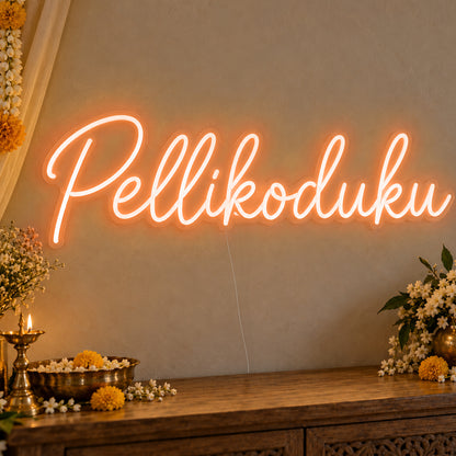 Pellikoduku Neon Sign in orange LED neon on clear acrylic, angled view