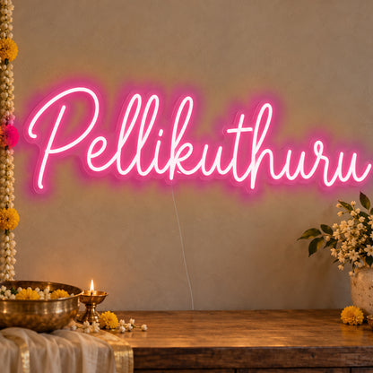 Pellikuthuru Neon Sign in rose red LED neon on clear acrylic, angled view