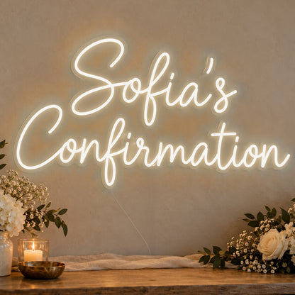 Personalised Confirmation Neon Sign in warm white LED neon on clear acrylic, angled view