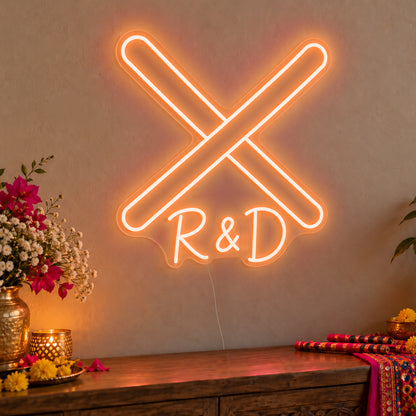 Personalised Dandiya Initials Neon Sign in orange LED neon on clear acrylic, angled view
