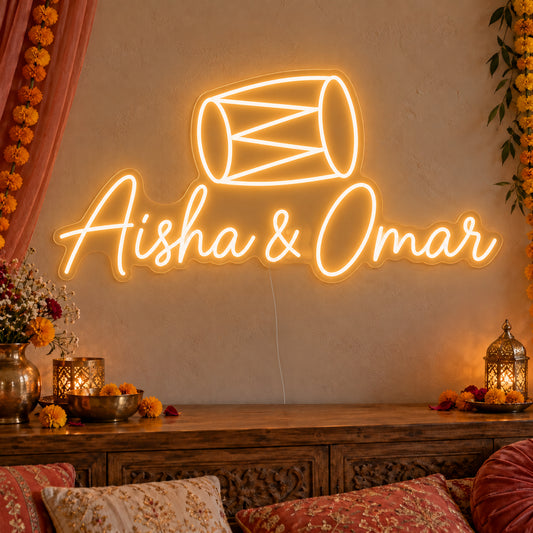 Personalised Dholki Drum Neon Sign on clear cut-to-shape acrylic, illuminated on a wall in a styled celebration setting; sample personalised wording shown