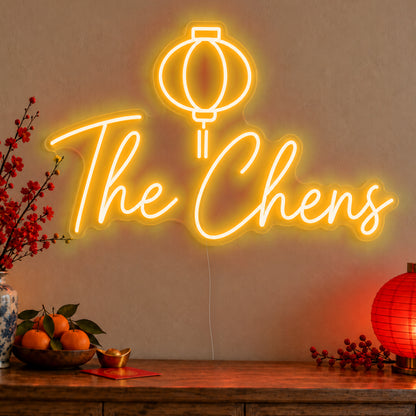Personalised Family Lantern Neon Sign in gold LED neon on clear acrylic, angled view
