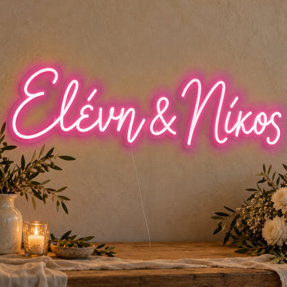 Personalised Greek Couple Names Neon Sign in rose red LED neon on clear acrylic, angled view