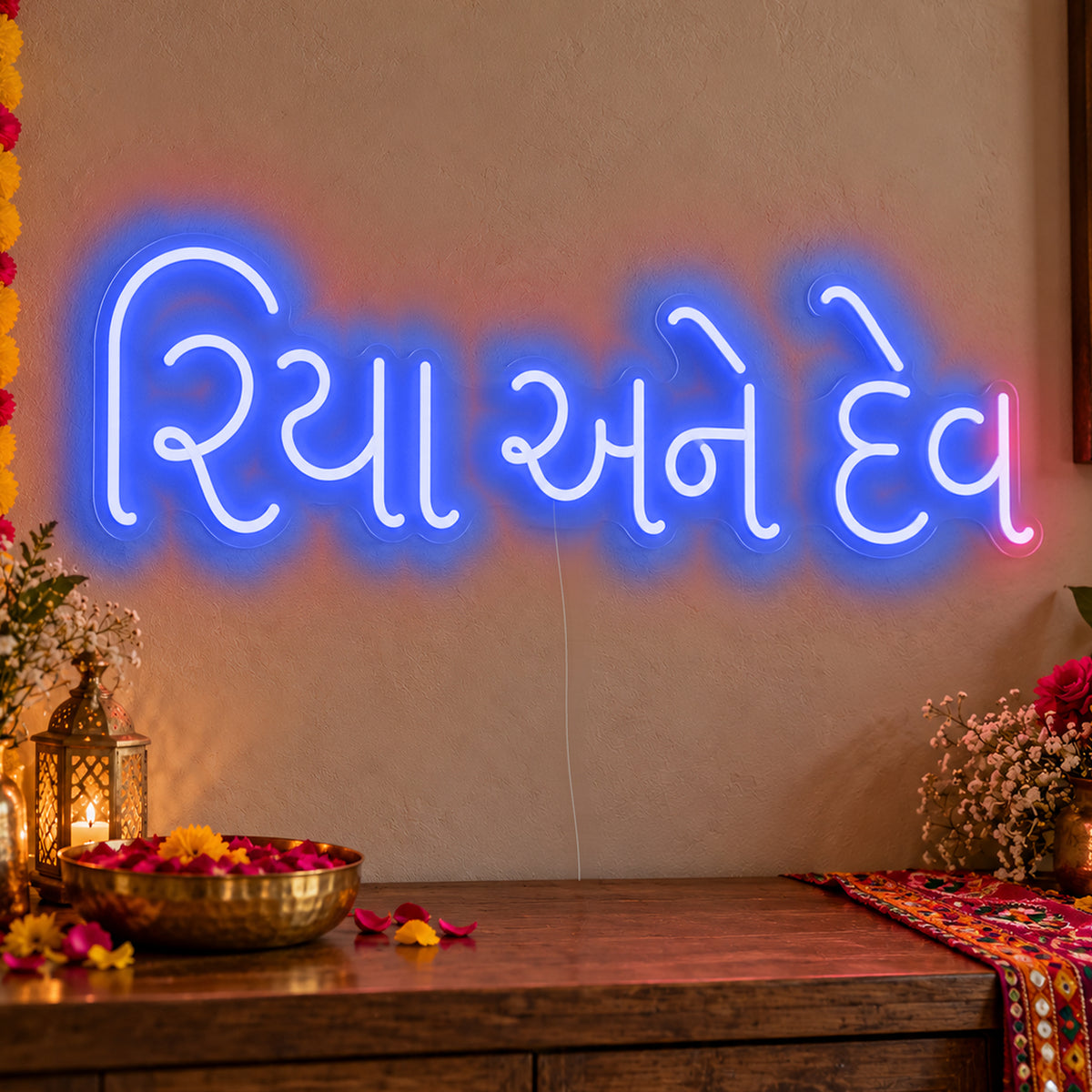 Personalised Gujarati Couple Names Neon Sign in blue LED neon on clear acrylic, angled view