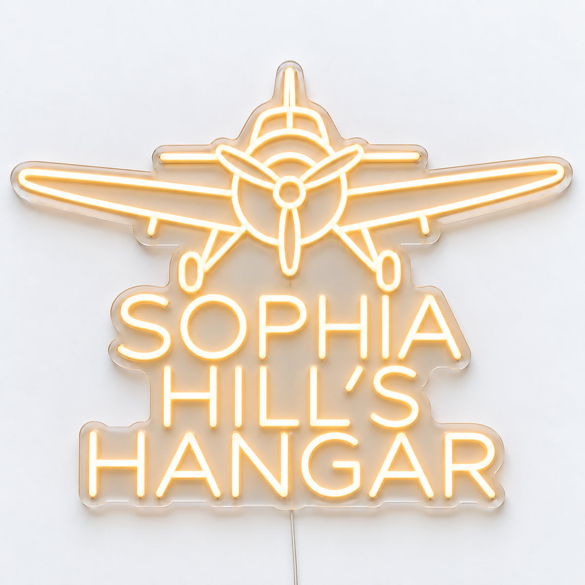 Personalised Hangar Neon Sign, featuring a personalised hangar sign, shown as Sophia Hill’s Hangar, on a single clear acrylic backing displayed on a white surface.