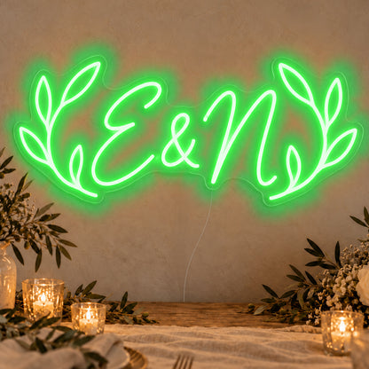 Personalised Olive Initials Neon Sign in green LED neon on clear acrylic, angled view