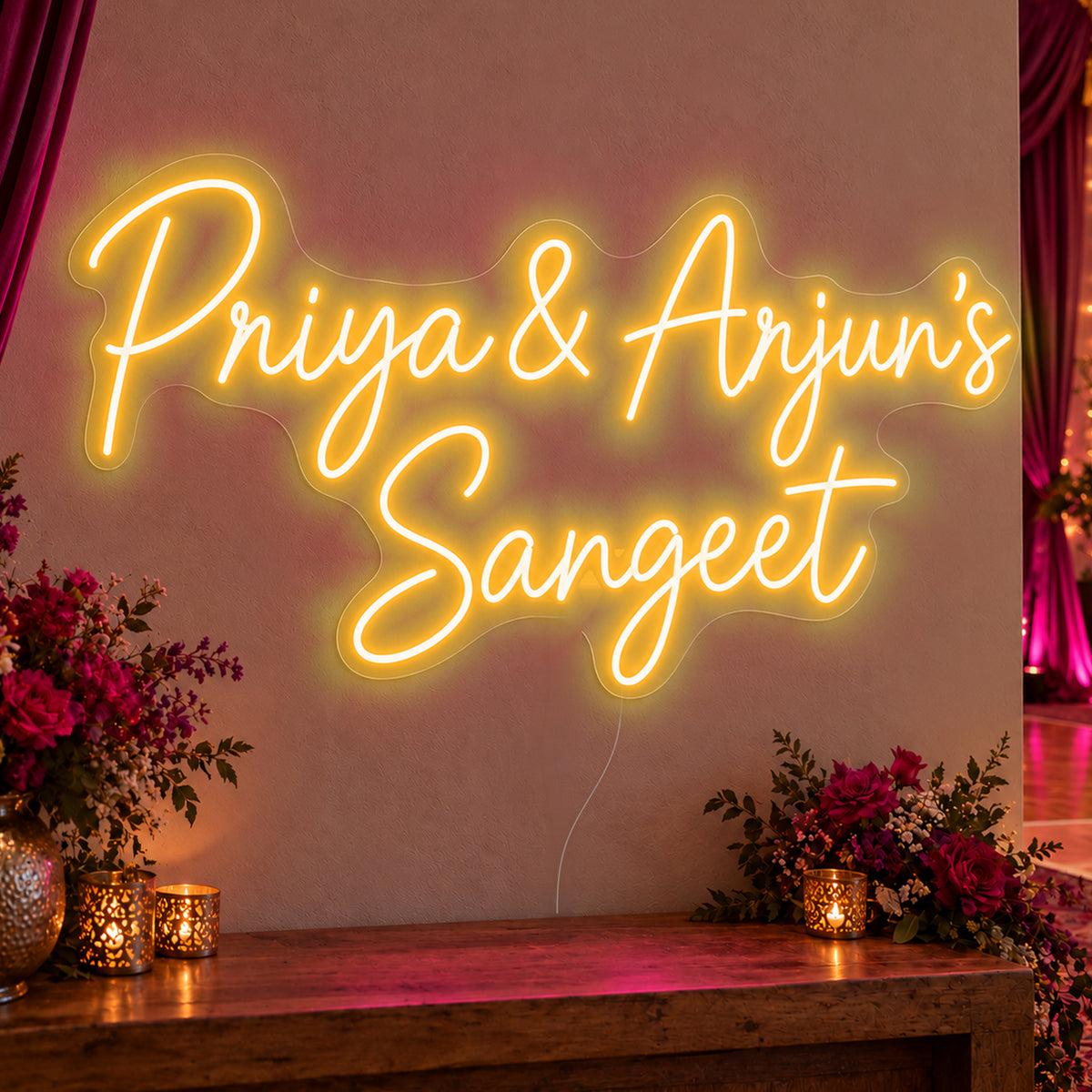 Personalised Sangeet Neon Sign in gold LED neon on clear acrylic, angled view