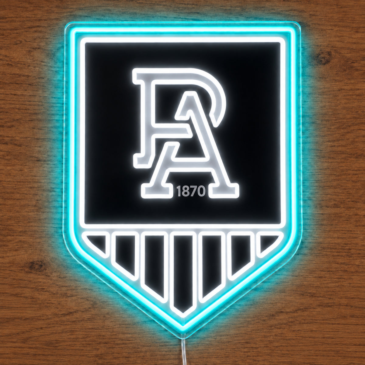 Port Adelaide Power neon sign glowing brightly on a wooden surface in dim lighting