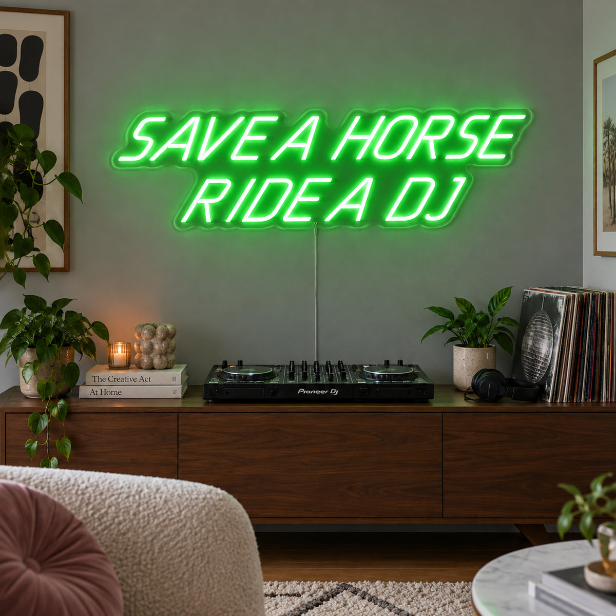 Save A Horse Ride A DJ Neon Sign with green lighting, displayed above a turntable on a wooden sideboard.