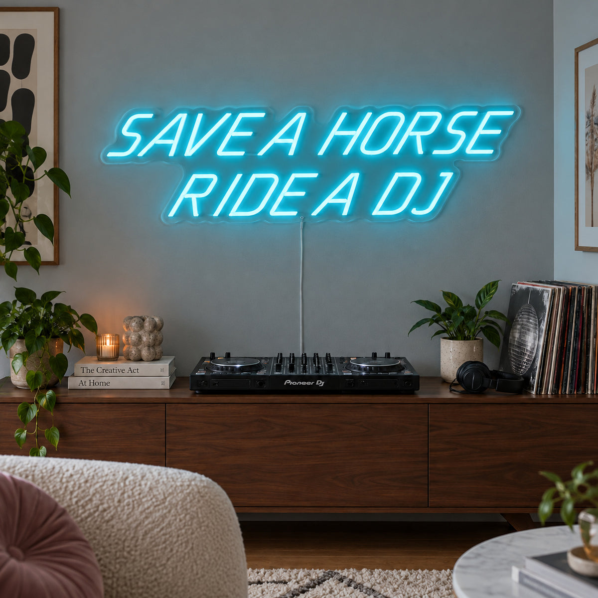 Ice Blue version of the Save A Horse Ride A DJ Neon Sign, shown above a turntable on a wooden sideboard.