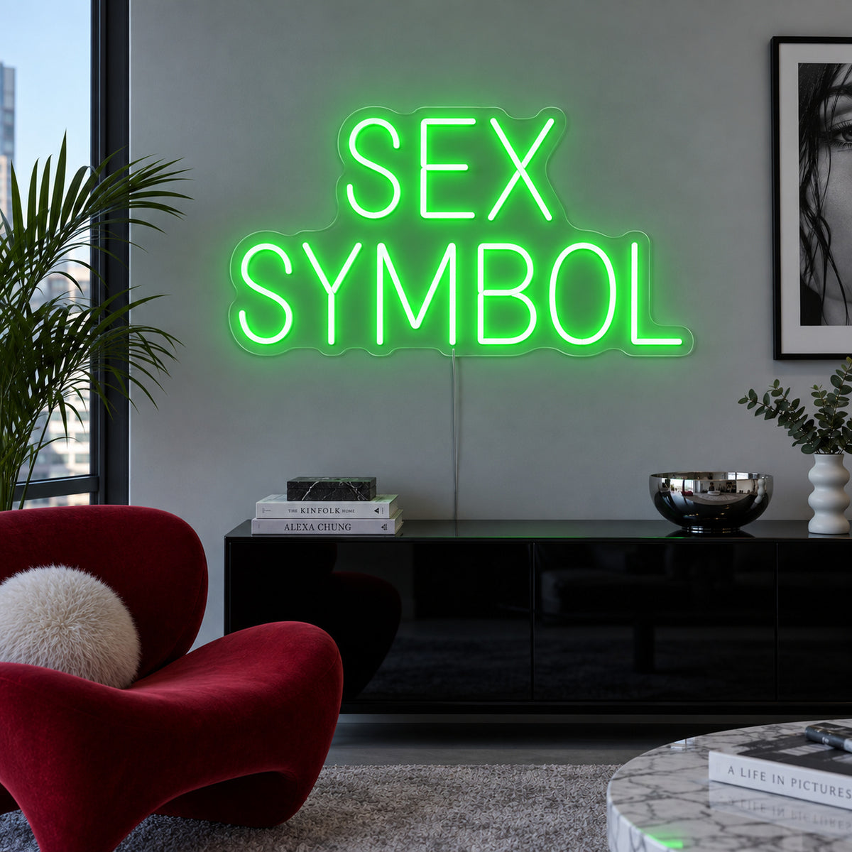 Sex Symbol Neon Sign with green lighting, displayed above a black sideboard.