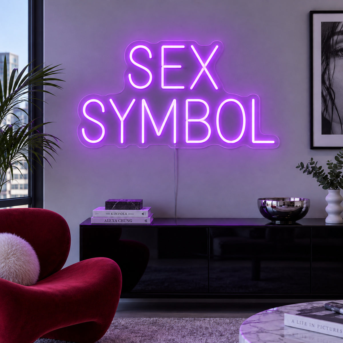Sex Symbol Neon Sign with purple lighting, displayed above a black sideboard.