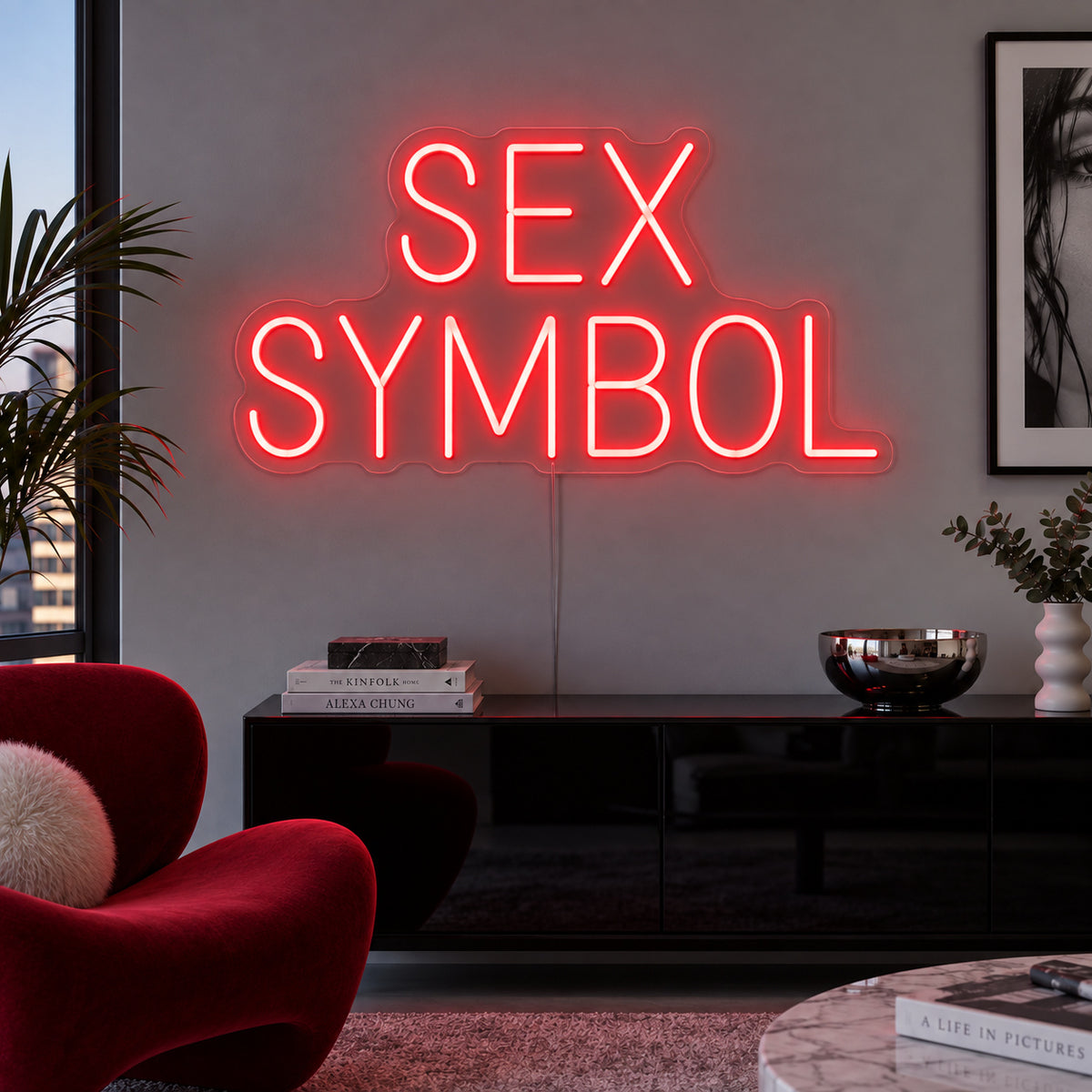 Sex Symbol Neon Sign with red lighting, displayed above a black sideboard.