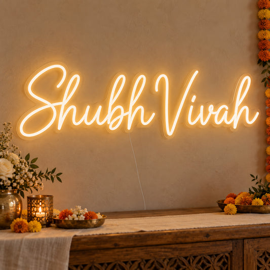 Shubh Vivah Neon Sign on clear cut-to-shape acrylic, illuminated on a wall in a styled celebration setting