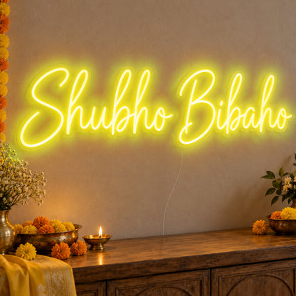 Shubho Bibaho Neon Sign in yellow LED neon on clear acrylic, angled view