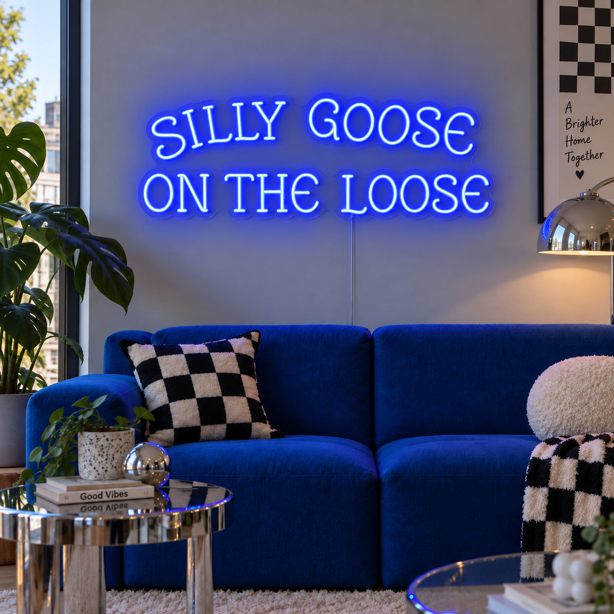 Silly Goose On The Loose Neon Sign glowing blue above a blue sofa with checkered cushions.