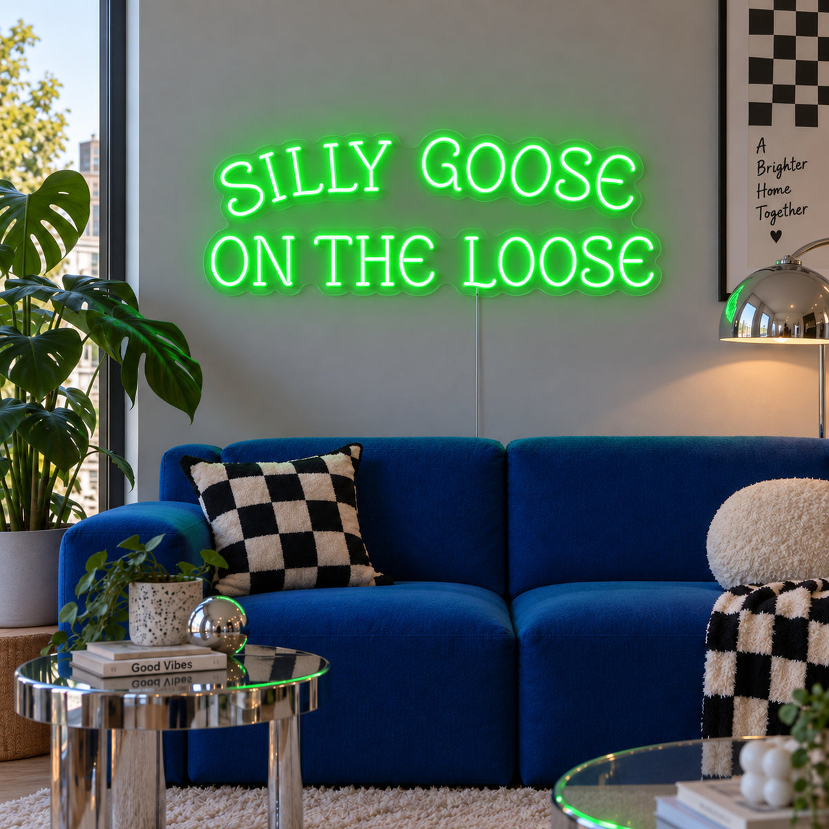 Silly Goose On The Loose Neon Sign with green lighting, displayed above a blue sofa with checkered cushions.