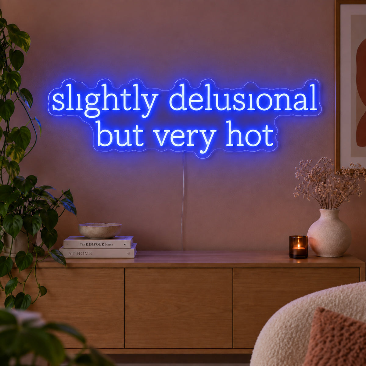 Slightly Delusional But Very Hot Neon Sign glowing blue above a wooden sideboard.