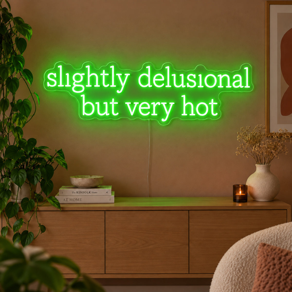 Slightly Delusional But Very Hot Neon Sign with green lighting, displayed above a wooden sideboard.