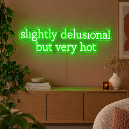 Slightly Delusional But Very Hot Neon Sign with green lighting, displayed above a wooden sideboard.