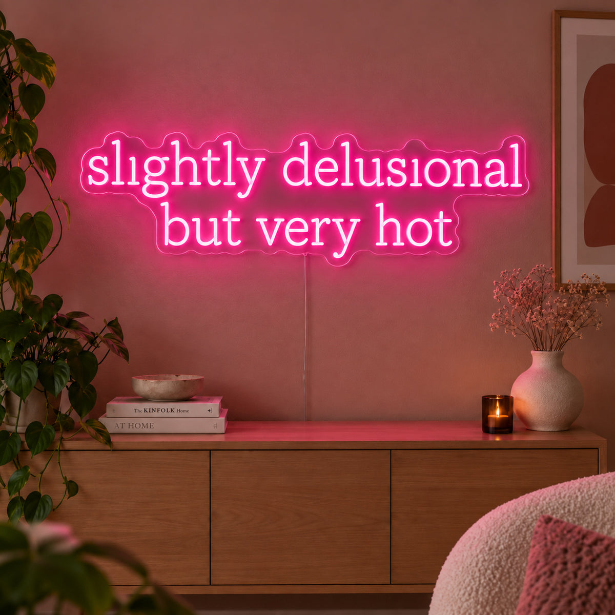 Rose Red version of the Slightly Delusional But Very Hot Neon Sign, shown above a wooden sideboard.