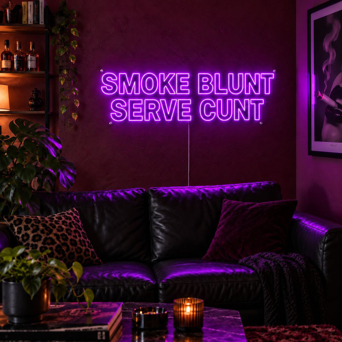 Smoke Blunt Serve Cunt Neon Sign with purple lighting, displayed above a black leather sofa.