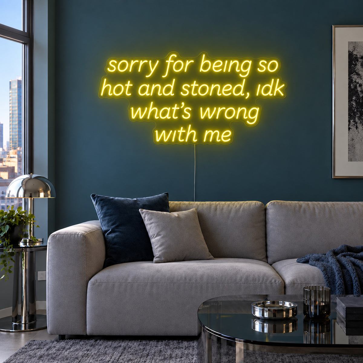 Sorry For Being So Hot And Stoned, Idk What's Wrong With Me Neon Sign with yellow lighting, displayed above a grey sofa against a blue wall.