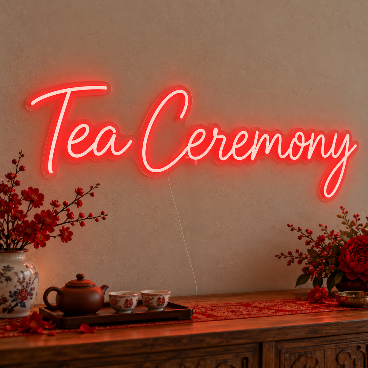 Tea Ceremony Neon Sign on clear cut-to-shape acrylic, illuminated on a wall in a styled celebration setting