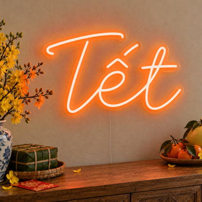 Tết Neon Sign in orange LED neon on clear acrylic, angled view