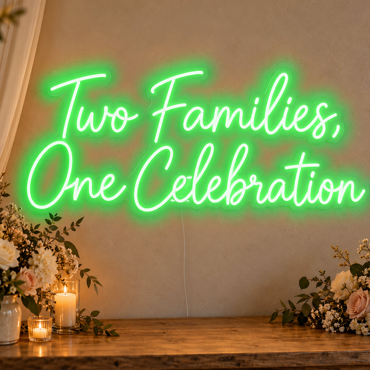 Two Families One Celebration Neon Sign in green LED neon on clear acrylic, angled view