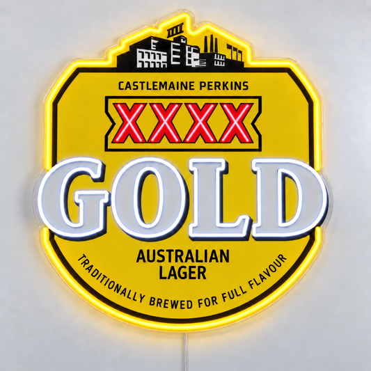 XXXX Gold LED neon sign with red XXXX lettering, white GOLD lettering and a yellow outline on clear acrylic, shown on a white table.