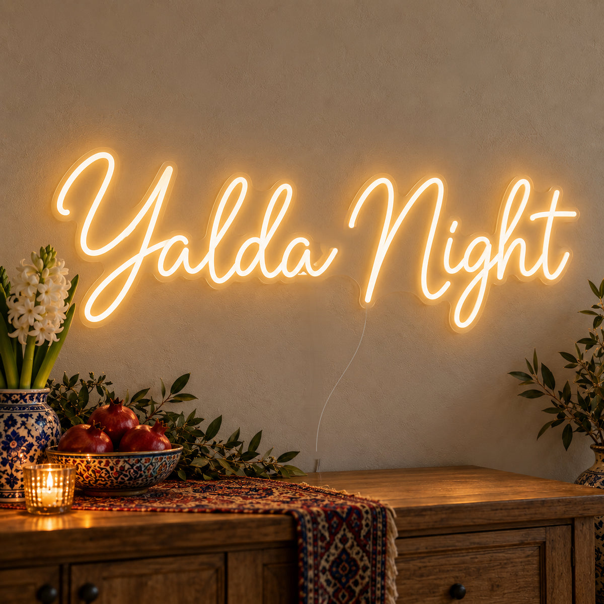 Yalda Night Neon Sign on clear cut-to-shape acrylic, illuminated on a wall in a styled celebration setting