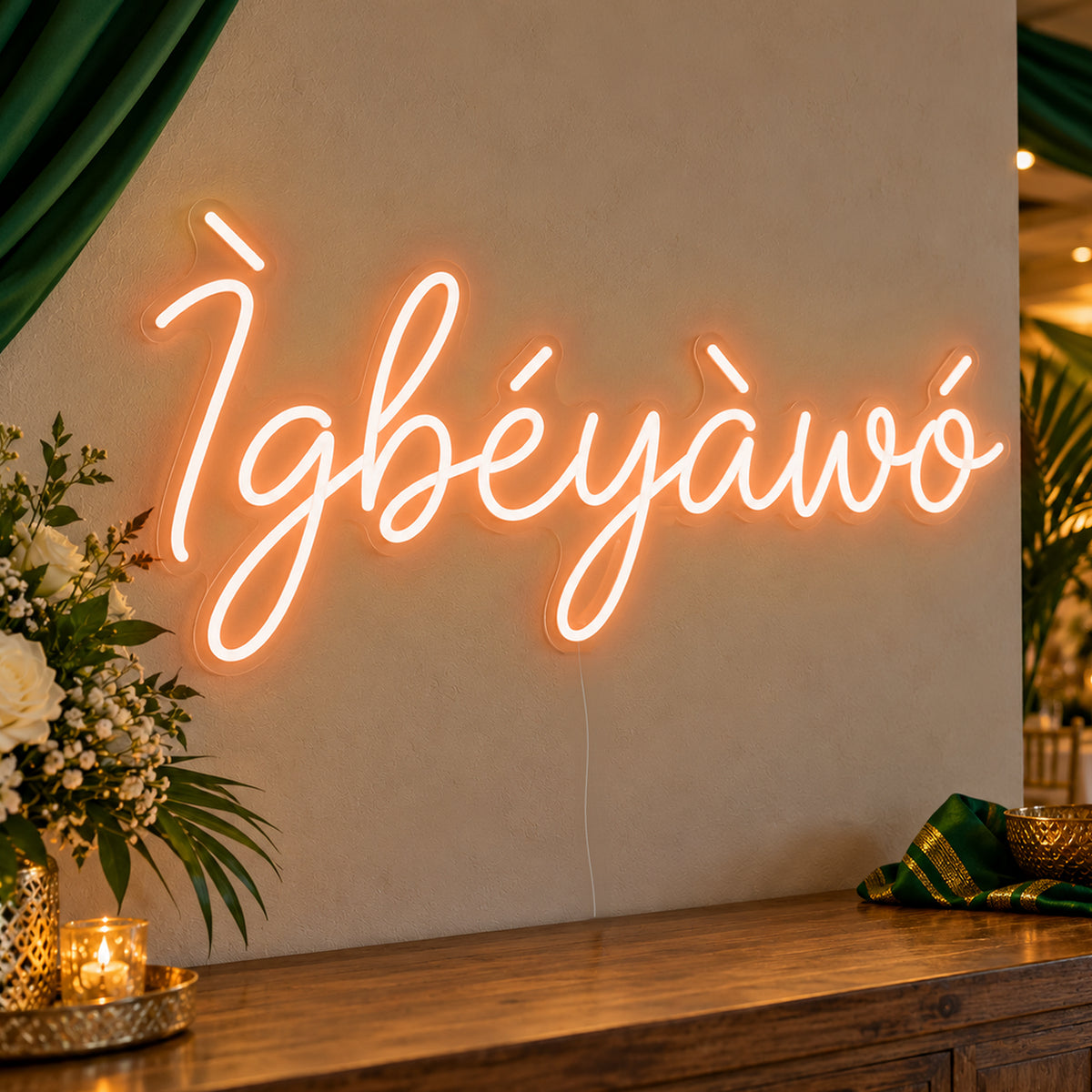 Ìgbéyàwó Yoruba Wedding Neon Sign in orange LED neon on clear acrylic, angled view
